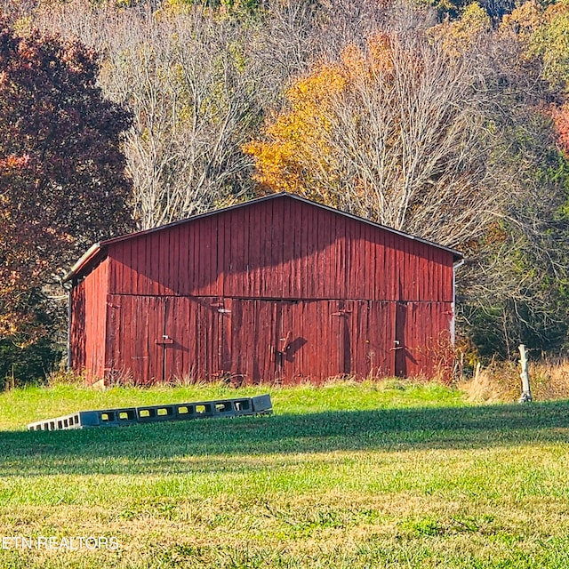 view of outbuilding with a lawn