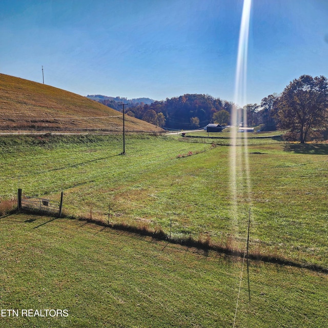 mountain view featuring a rural view