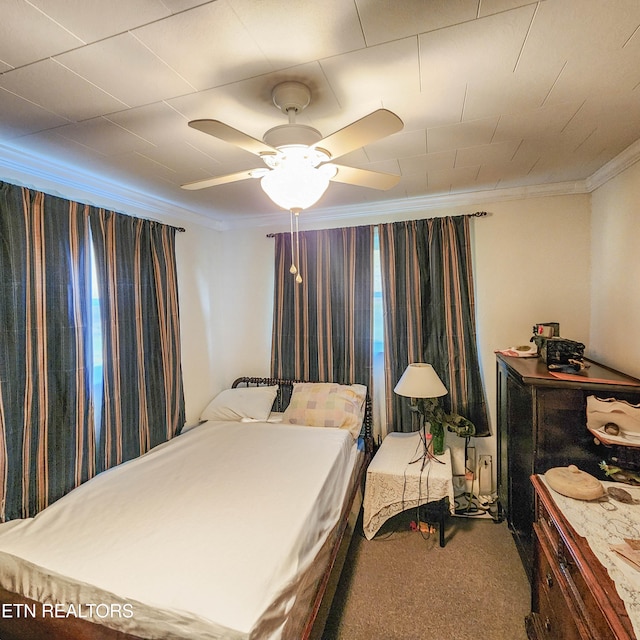 bedroom with ornamental molding, carpet, and ceiling fan