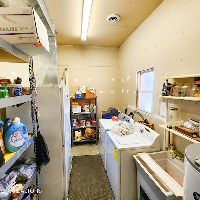 washroom featuring separate washer and dryer and sink