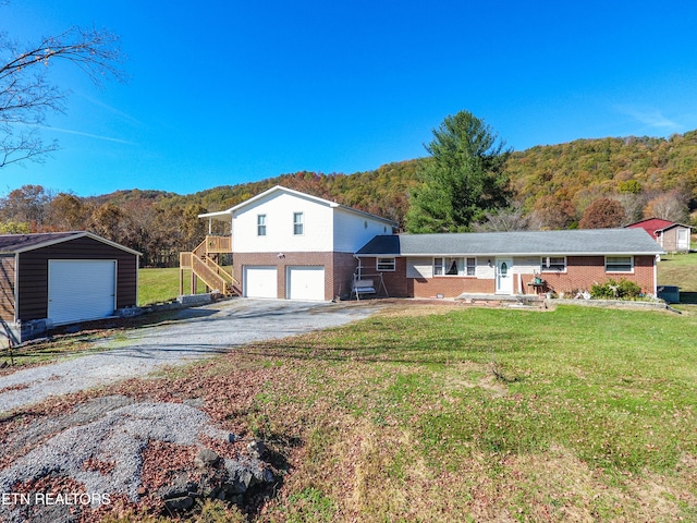 view of front of property with an outbuilding, a garage, and a front yard