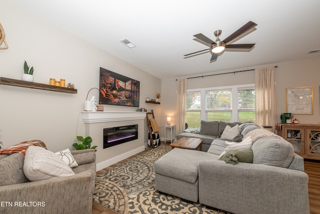 living room with ceiling fan and hardwood / wood-style floors