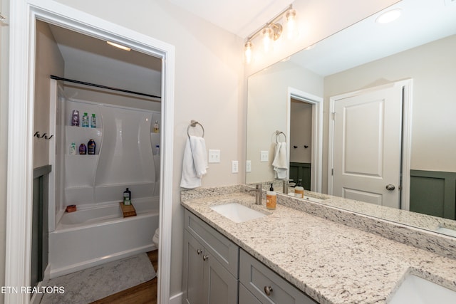 full bathroom with vanity, hardwood / wood-style floors, shower / bathing tub combination, and toilet