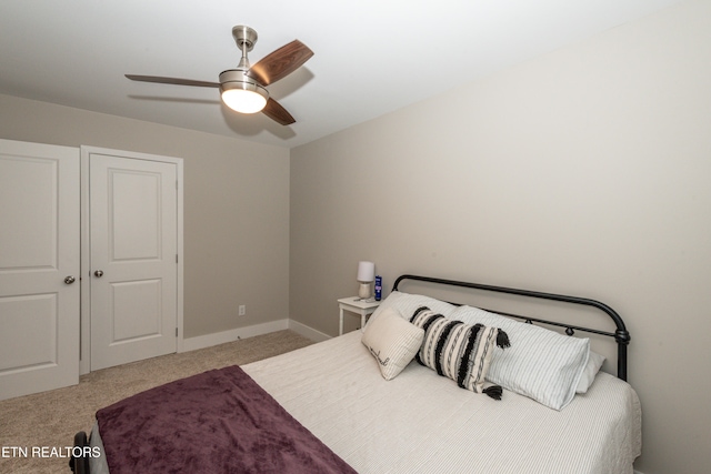 bedroom with light colored carpet and ceiling fan