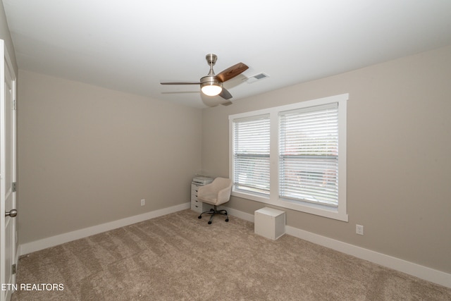 unfurnished room featuring ceiling fan and light colored carpet