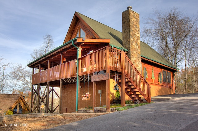 back of house with a deck