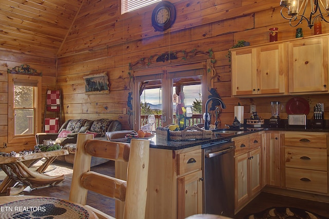 919 Buck Way, Sevierville, TN 37876 - kitchen with stainless steel dishwasher, vaulted ceiling, wooden walls, a chandelier, and a sink