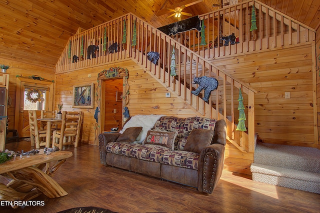 living room with hardwood / wood-style floors, wooden walls, high vaulted ceiling, and wooden ceiling