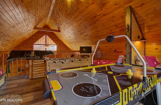 game room with lofted ceiling with beams, wood walls, wood-type flooring, and wooden ceiling