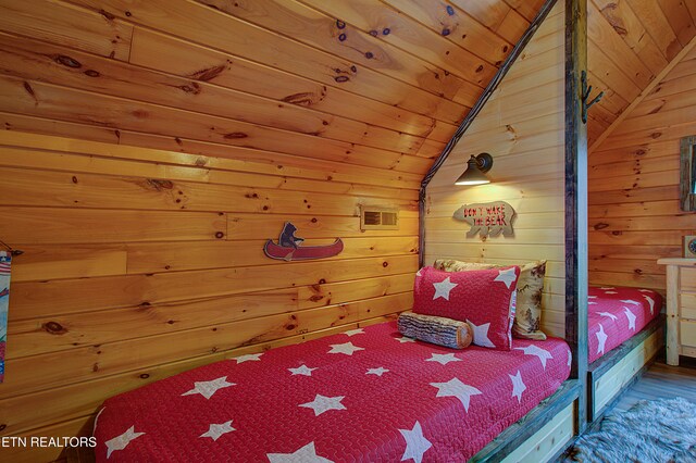 bedroom with hardwood / wood-style floors, wooden ceiling, lofted ceiling, and wood walls