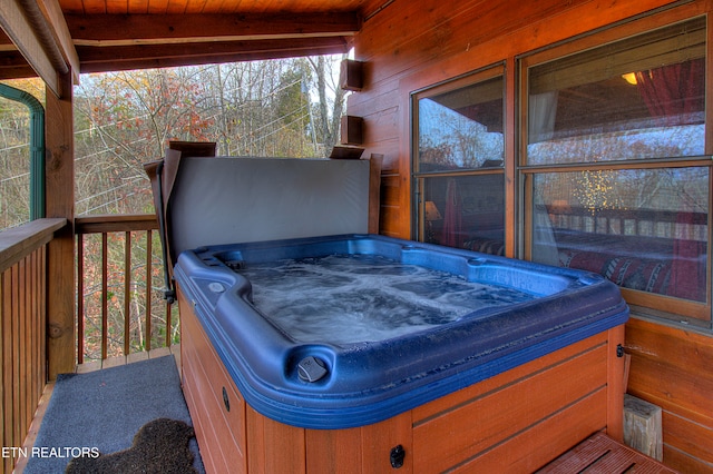 wooden terrace featuring a hot tub