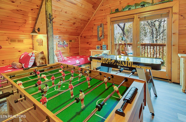 recreation room with hardwood / wood-style floors, wood walls, wood ceiling, and vaulted ceiling