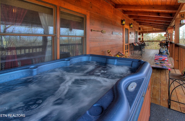 view of patio / terrace featuring a wooden deck and a hot tub