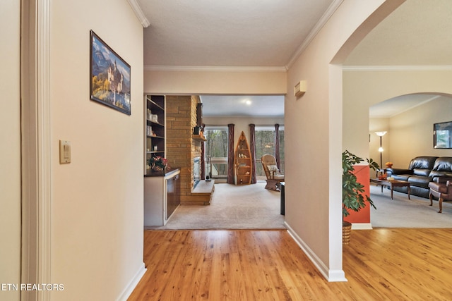 hall featuring light hardwood / wood-style flooring and crown molding