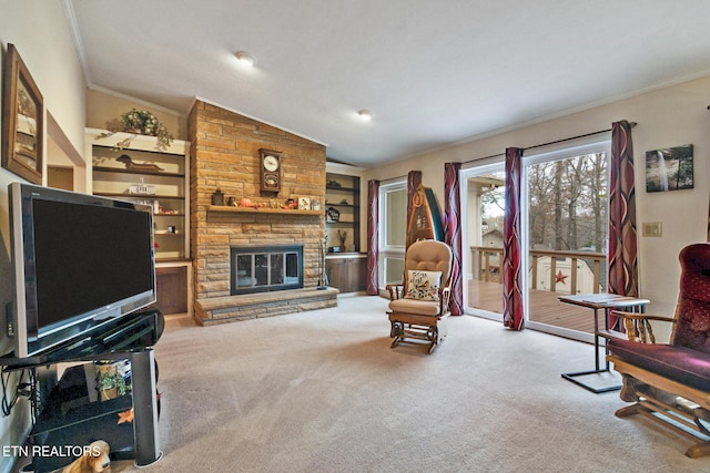 carpeted living room featuring built in features, a stone fireplace, lofted ceiling, and crown molding