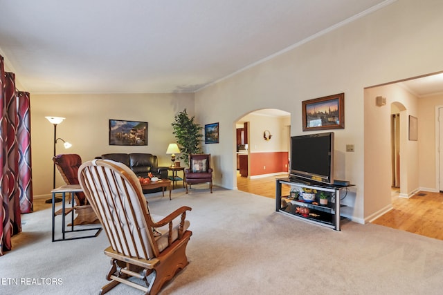 living room featuring crown molding, light carpet, and vaulted ceiling