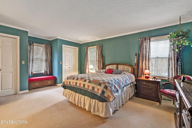 bedroom with light colored carpet, ornamental molding, and a textured ceiling