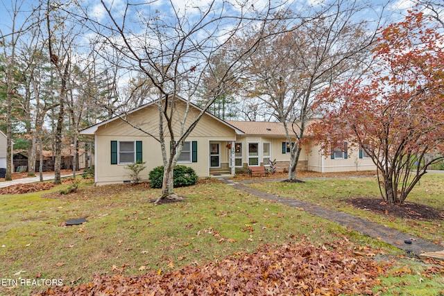 ranch-style home with a front yard