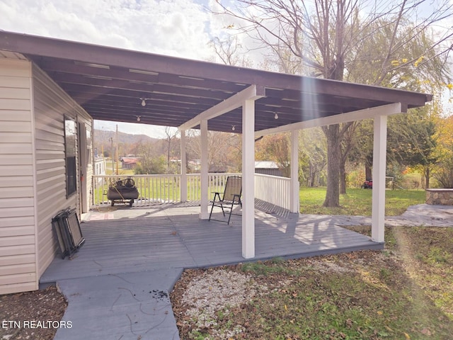 view of patio with a deck with mountain view and a pergola