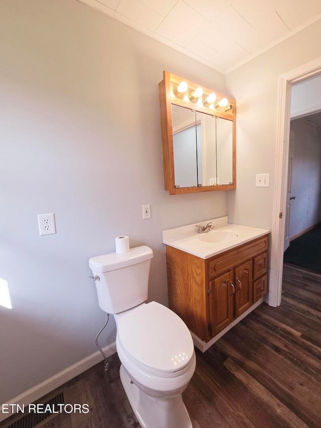 bathroom with vanity, toilet, and wood-type flooring