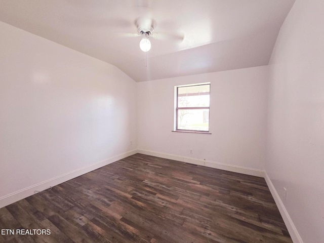 spare room featuring ceiling fan, vaulted ceiling, and dark hardwood / wood-style floors