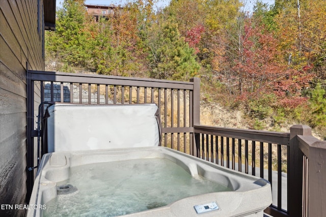 wooden deck with a hot tub