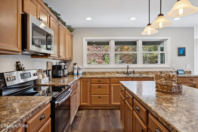 kitchen with stainless steel appliances, sink, pendant lighting, light stone counters, and dark hardwood / wood-style flooring