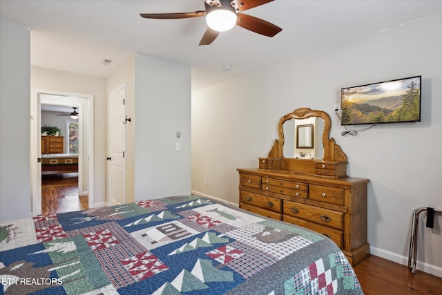 bedroom with dark hardwood / wood-style flooring and ceiling fan