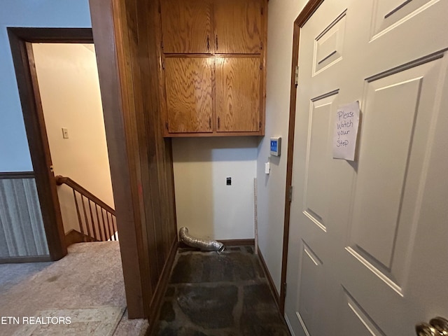 washroom with hookup for an electric dryer, light carpet, and cabinets