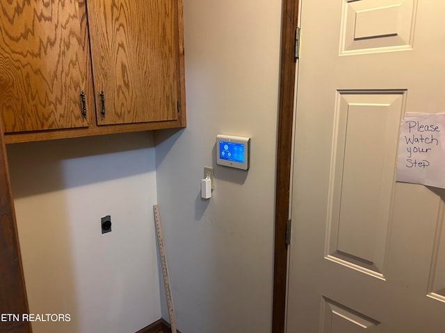 laundry area featuring cabinets and electric dryer hookup