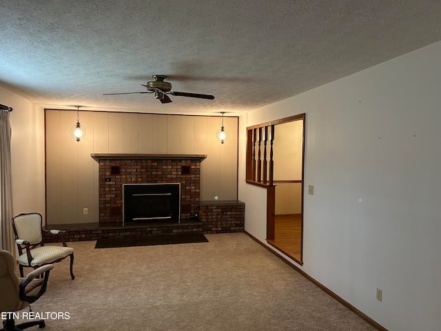 living room with a fireplace, dark colored carpet, a textured ceiling, and ceiling fan