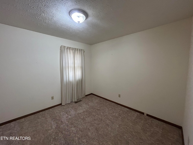 unfurnished room with carpet floors and a textured ceiling