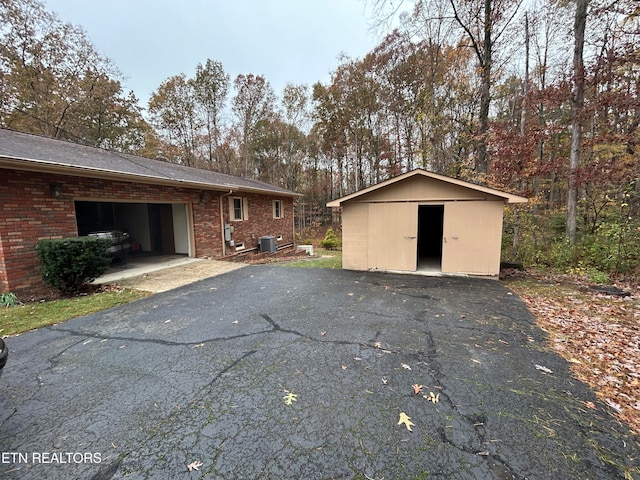 exterior space featuring central AC and a garage