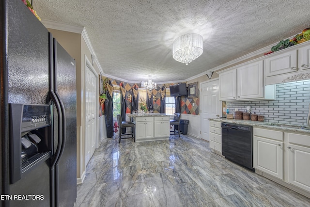 kitchen with white cabinets, a breakfast bar area, ornamental molding, black appliances, and a notable chandelier