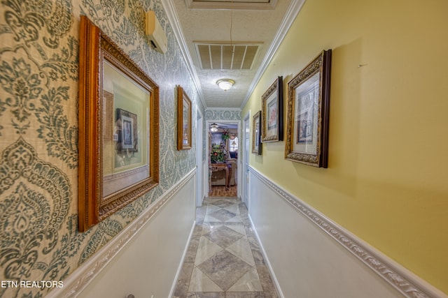 corridor featuring ornamental molding and a textured ceiling