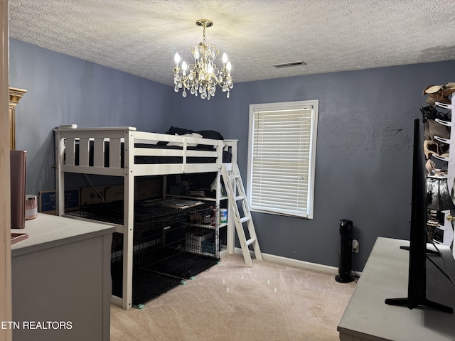 bedroom featuring a textured ceiling, carpet, visible vents, and baseboards