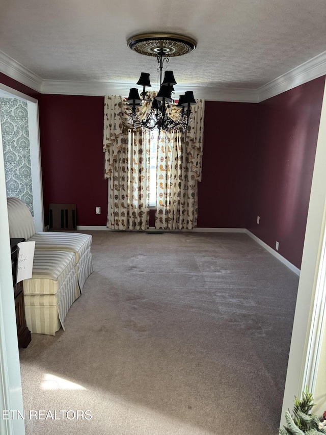 interior space featuring a notable chandelier, a textured ceiling, baseboards, and crown molding