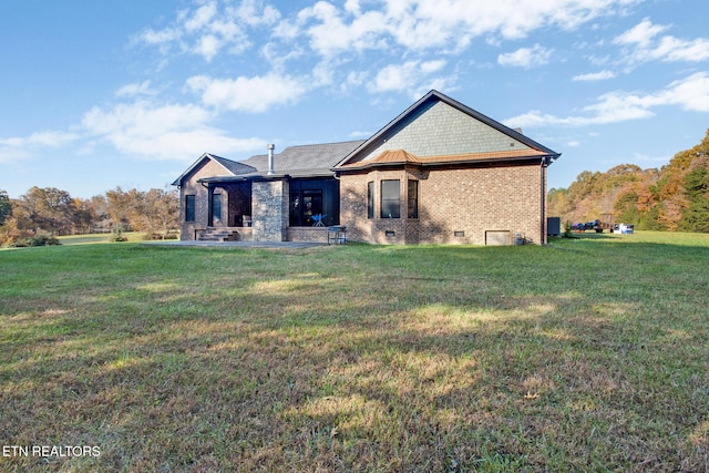 rear view of house with a patio and a yard