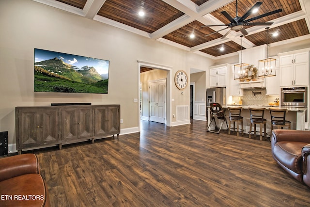 living room with beam ceiling, dark hardwood / wood-style flooring, wooden ceiling, ceiling fan with notable chandelier, and crown molding