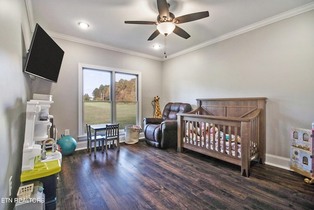 bedroom featuring ornamental molding, a nursery area, and dark hardwood / wood-style floors