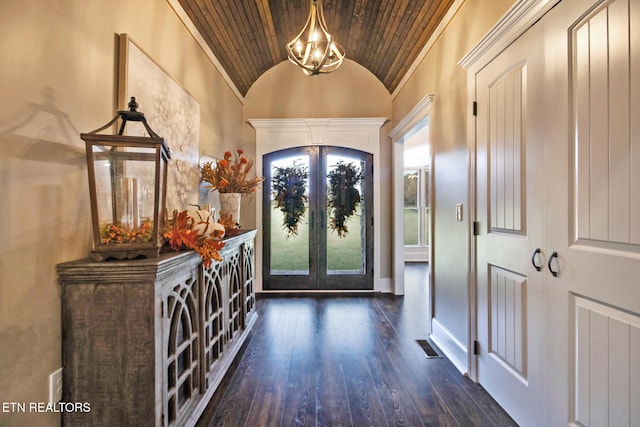 foyer with wooden ceiling, vaulted ceiling, ornamental molding, dark hardwood / wood-style floors, and french doors