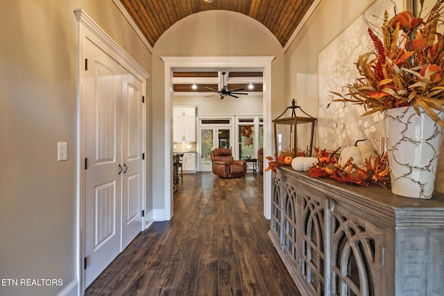 hall featuring vaulted ceiling with beams, wood ceiling, and dark hardwood / wood-style flooring