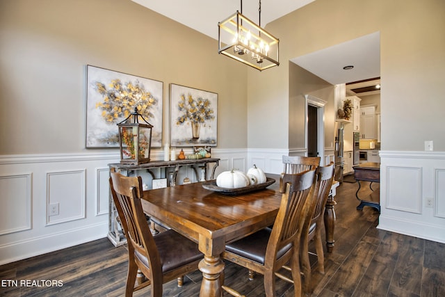 dining space featuring a notable chandelier and dark hardwood / wood-style flooring