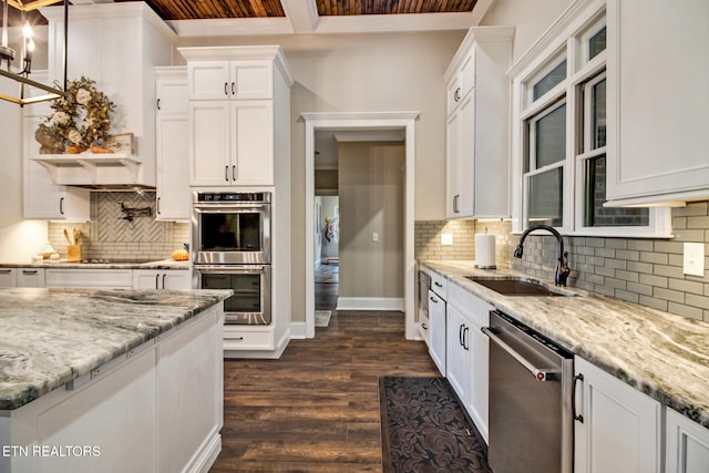 kitchen featuring appliances with stainless steel finishes, dark hardwood / wood-style floors, white cabinets, and tasteful backsplash