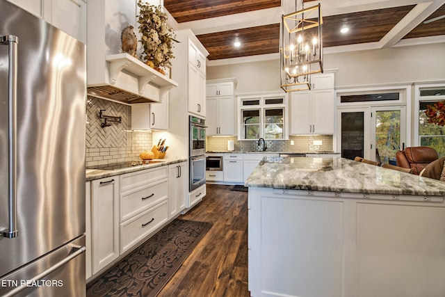 kitchen featuring dark hardwood / wood-style floors, stainless steel appliances, wooden ceiling, a center island, and white cabinetry