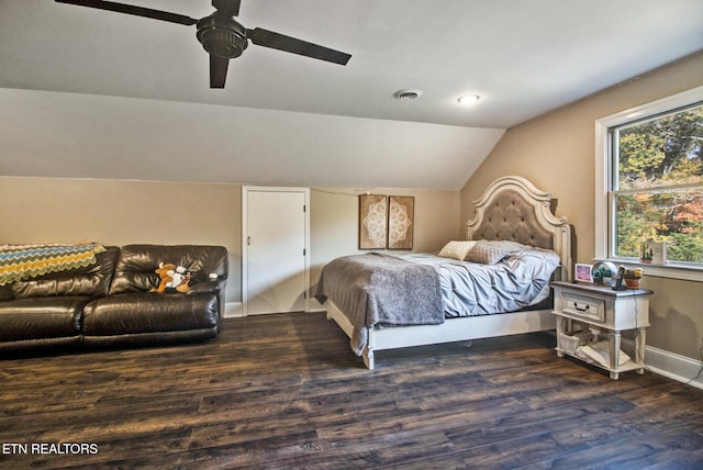 bedroom featuring dark wood-type flooring, vaulted ceiling, and ceiling fan