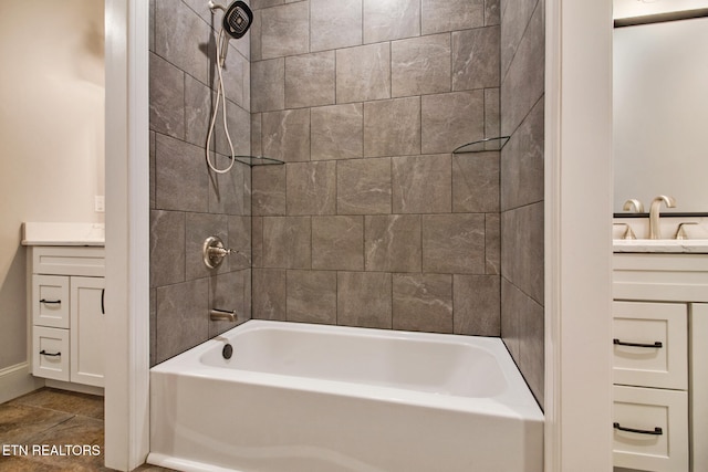 bathroom with tiled shower / bath and vanity