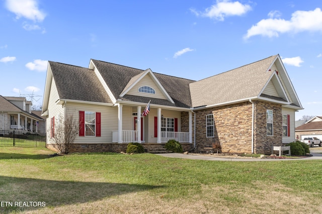 craftsman-style house featuring covered porch and a front yard