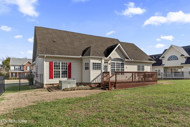 back of property with a lawn, central AC unit, and a wooden deck