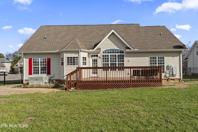 rear view of property featuring cooling unit, a deck, and a yard